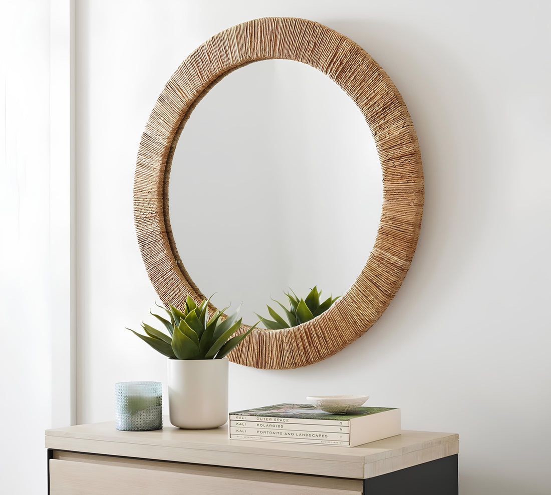 Small living room decorated with a large round rattan wall mirror and woven natural decor to feel bigger