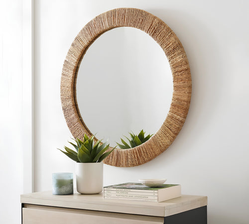 Rattan wall mirror hung in an Indian living room as a guide to where to place a mirror