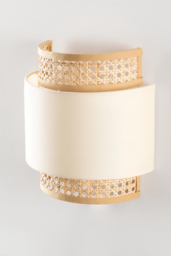 Bamboo and rattan wall lamp mounted beside a bedroom headboard casting warm light - Akway