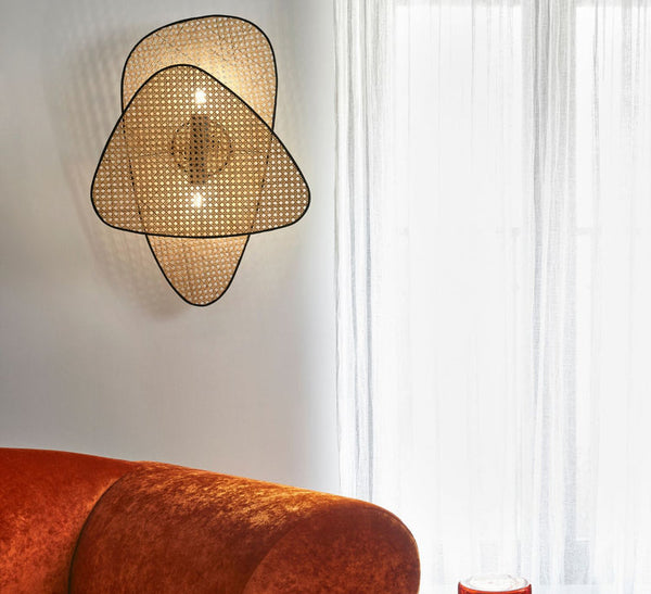 Wicker wall lamp mounted as a bedside sconce in a bedroom - Akway