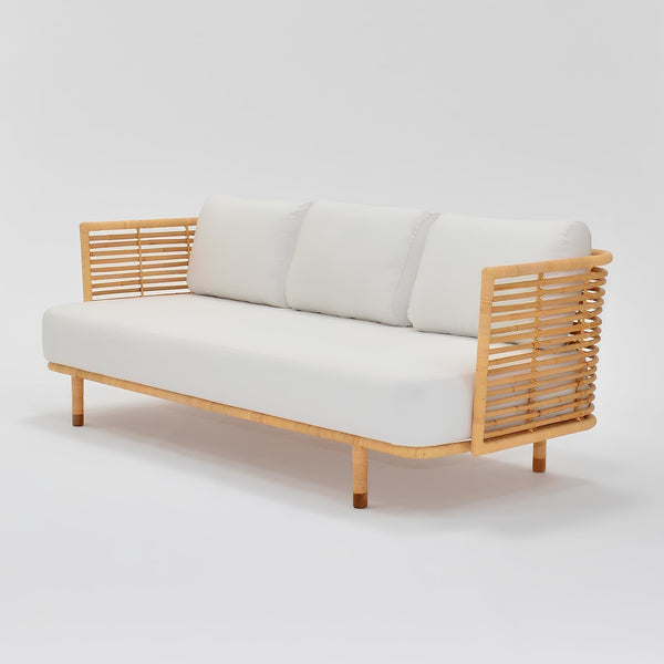 Cane outdoor sofa on a balcony in a humid coastal Indian home